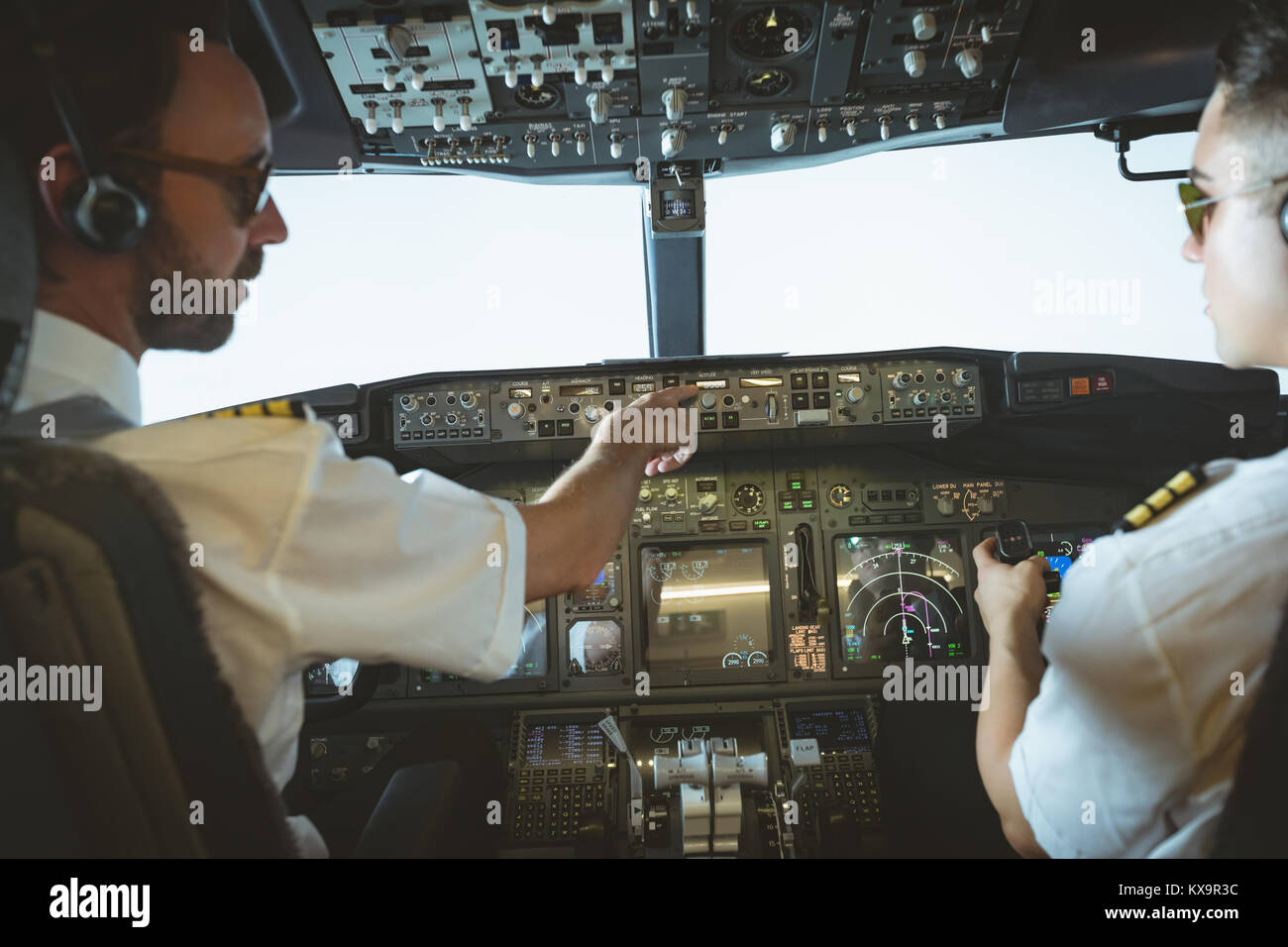 Pilot and copilot flying an airplane Stock Photo Alamy
