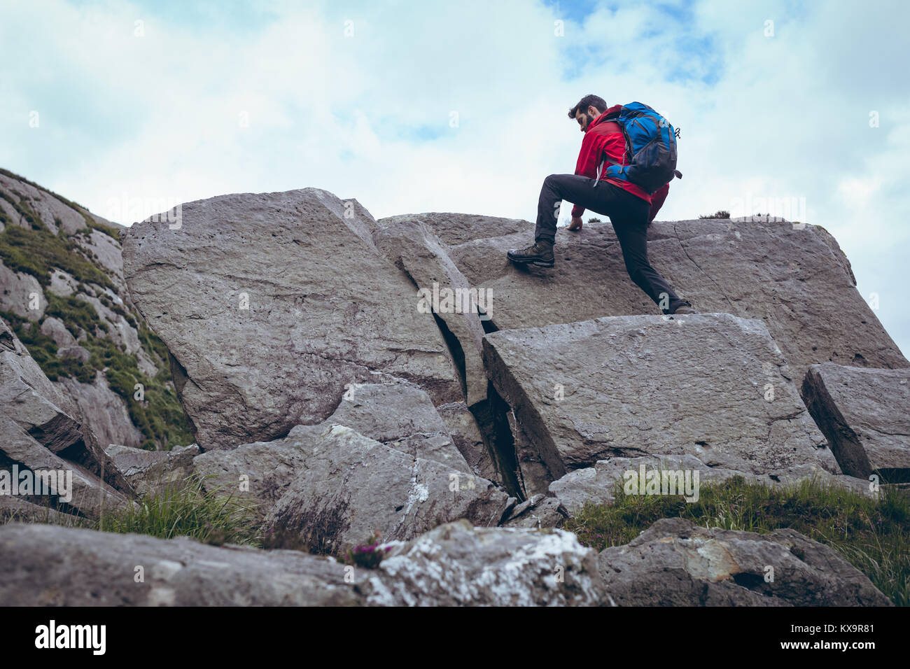 Male hiker climbing the rocks Stock Photo - Alamy