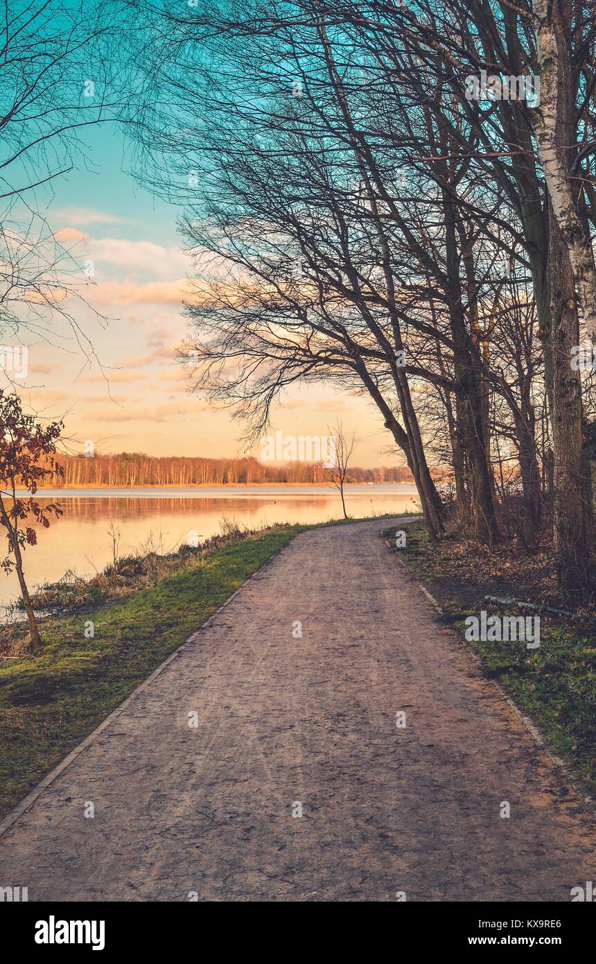 Beautiful urban landscape. Recreation path at the lake in the city. Stock Photo