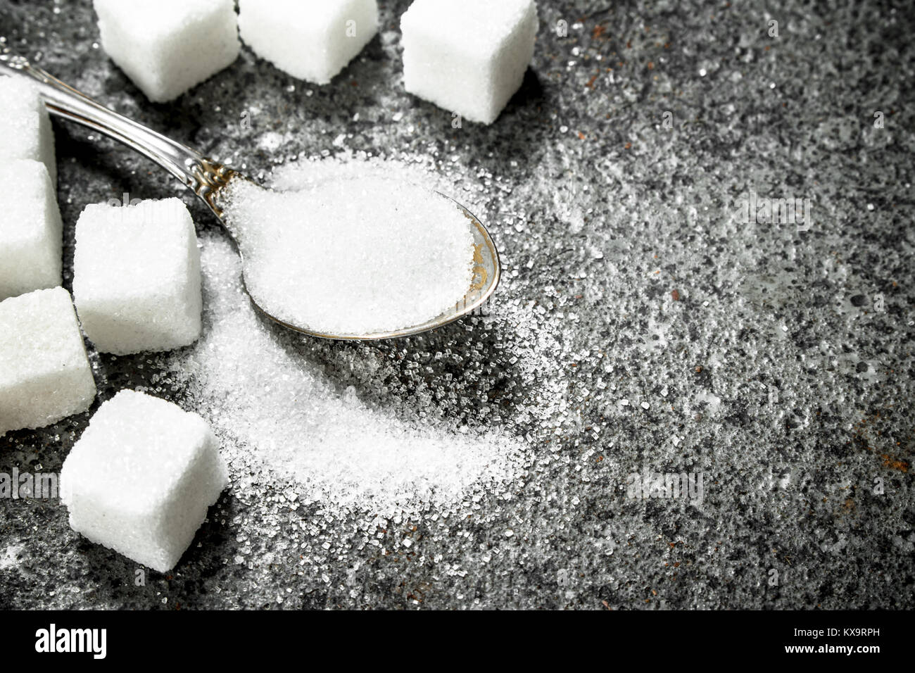 Sugar in a teaspoon. On a rustic background Stock Photo Alamy