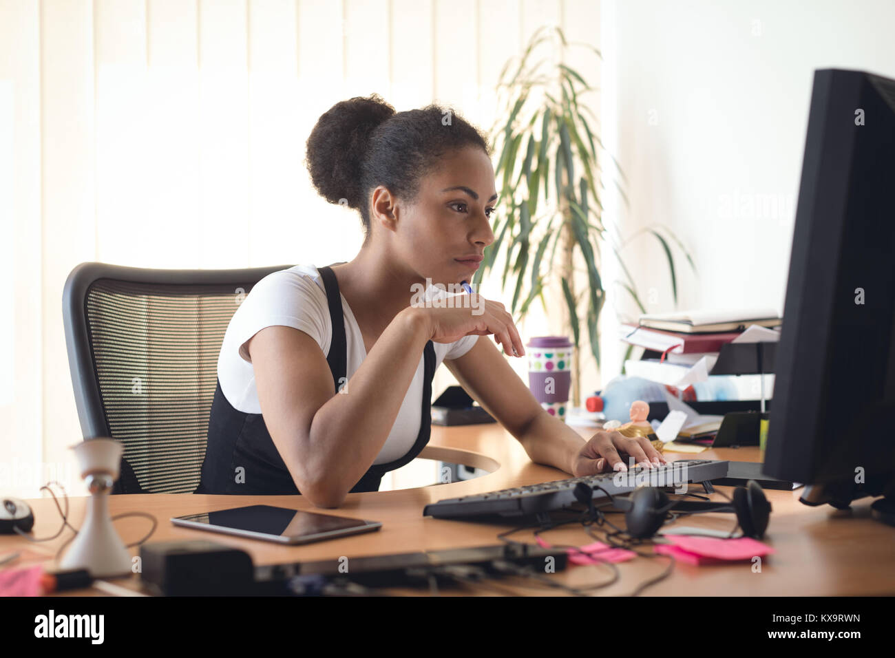 Female executive working on computer Stock Photo - Alamy