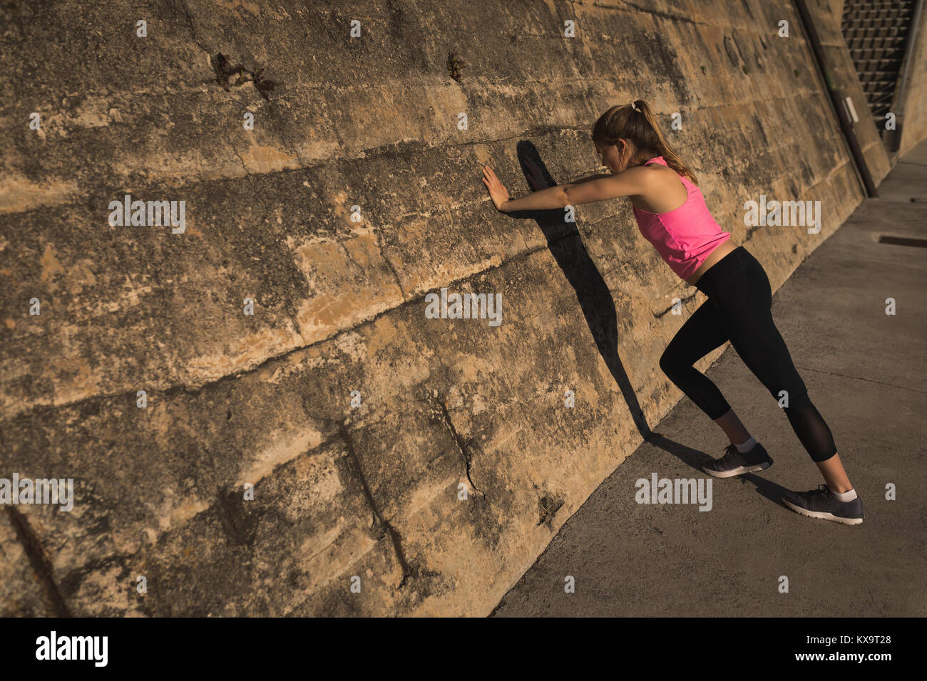 Female doing pushups while standing near wall Stock Photo Alamy