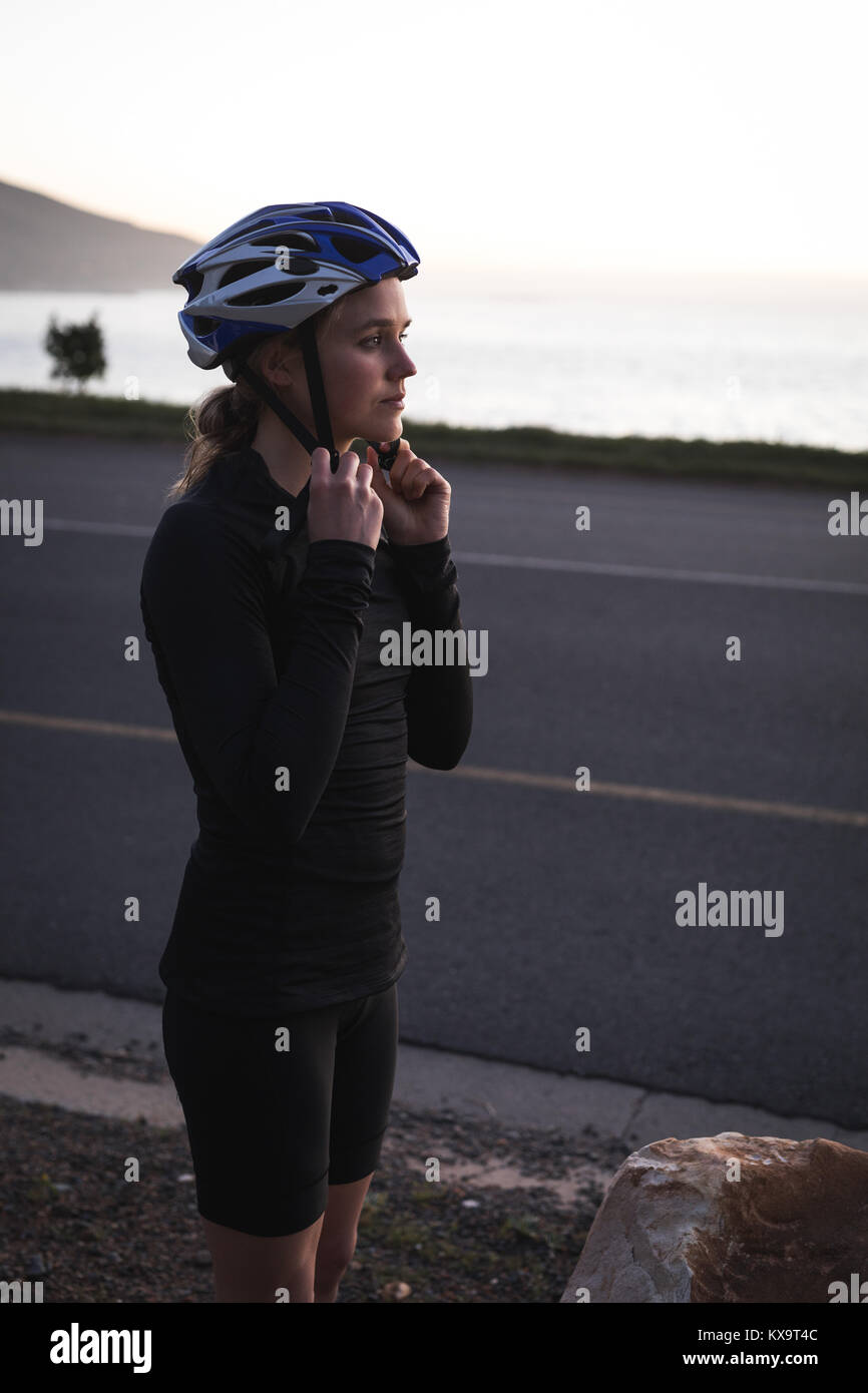 Woman getting ready to ride bicycle Stock Photo