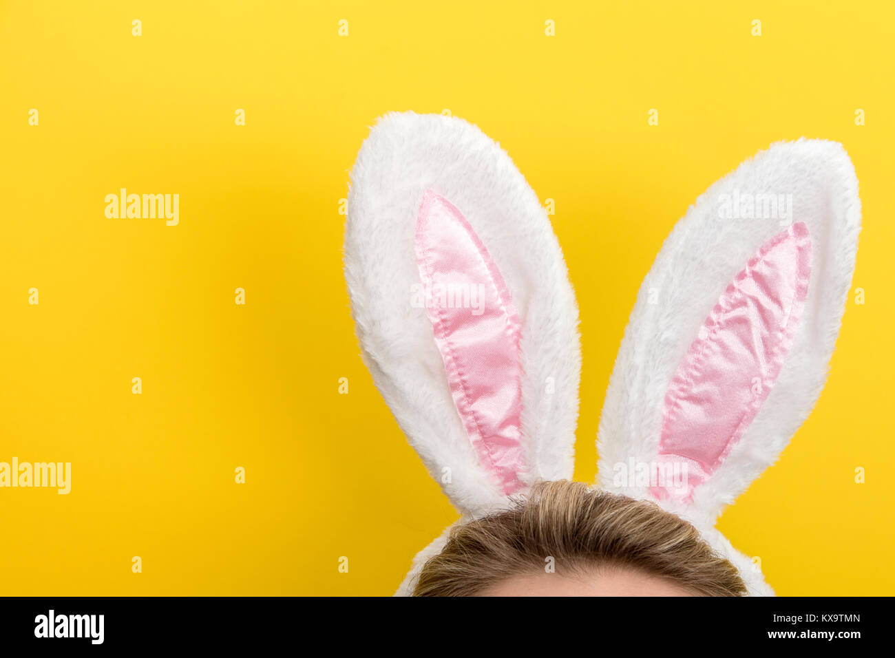 Easter bunny ears. Female wearing white bunny ears costume against a