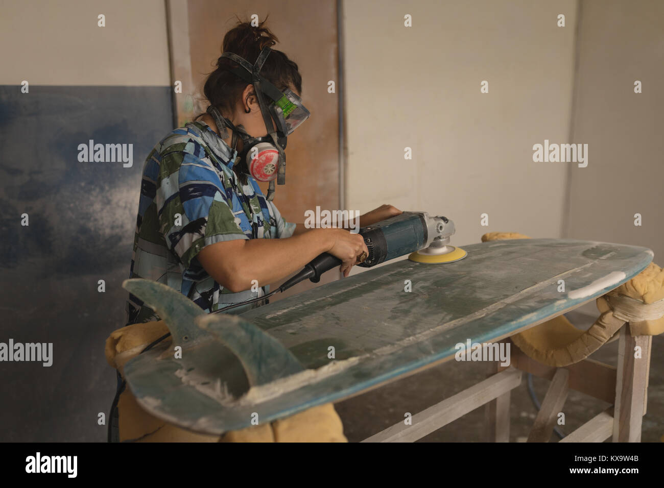 Male worker polishing surfboard with polishing machine Stock Photo Alamy