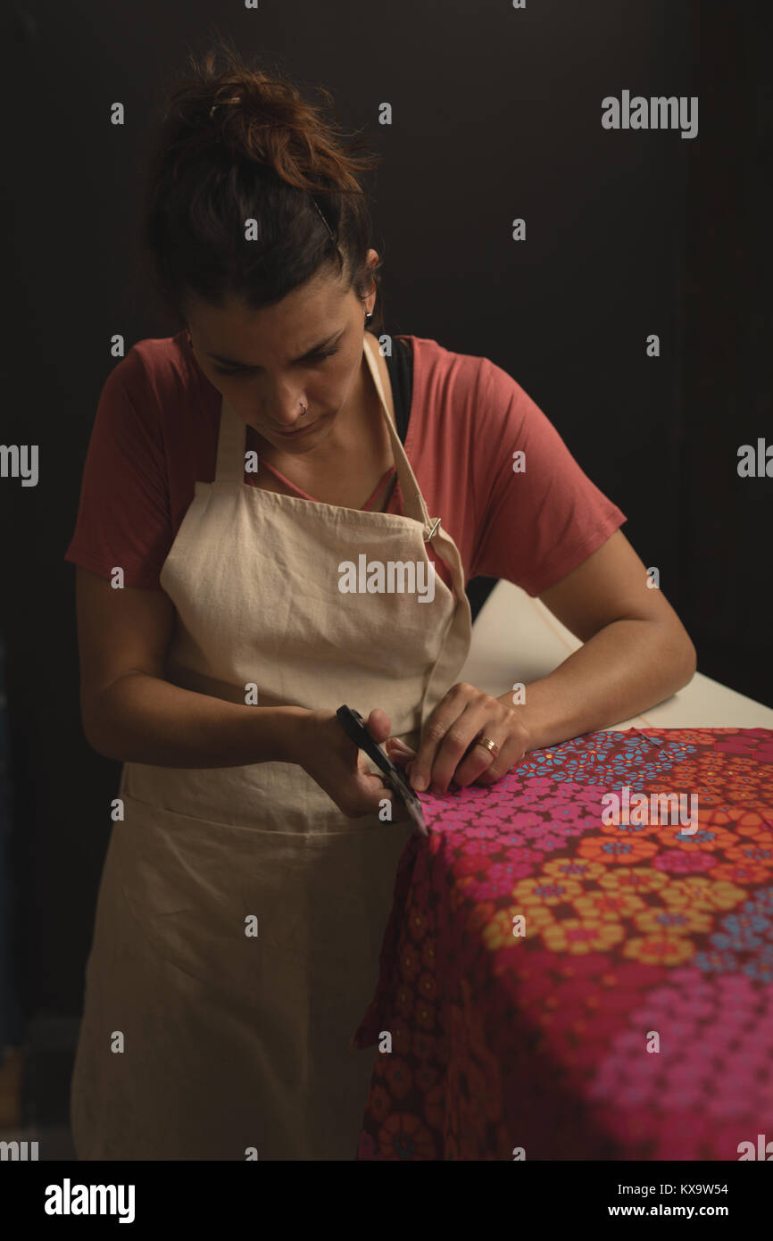 Female worker cutting design clothes with scissor Stock Photo Alamy
