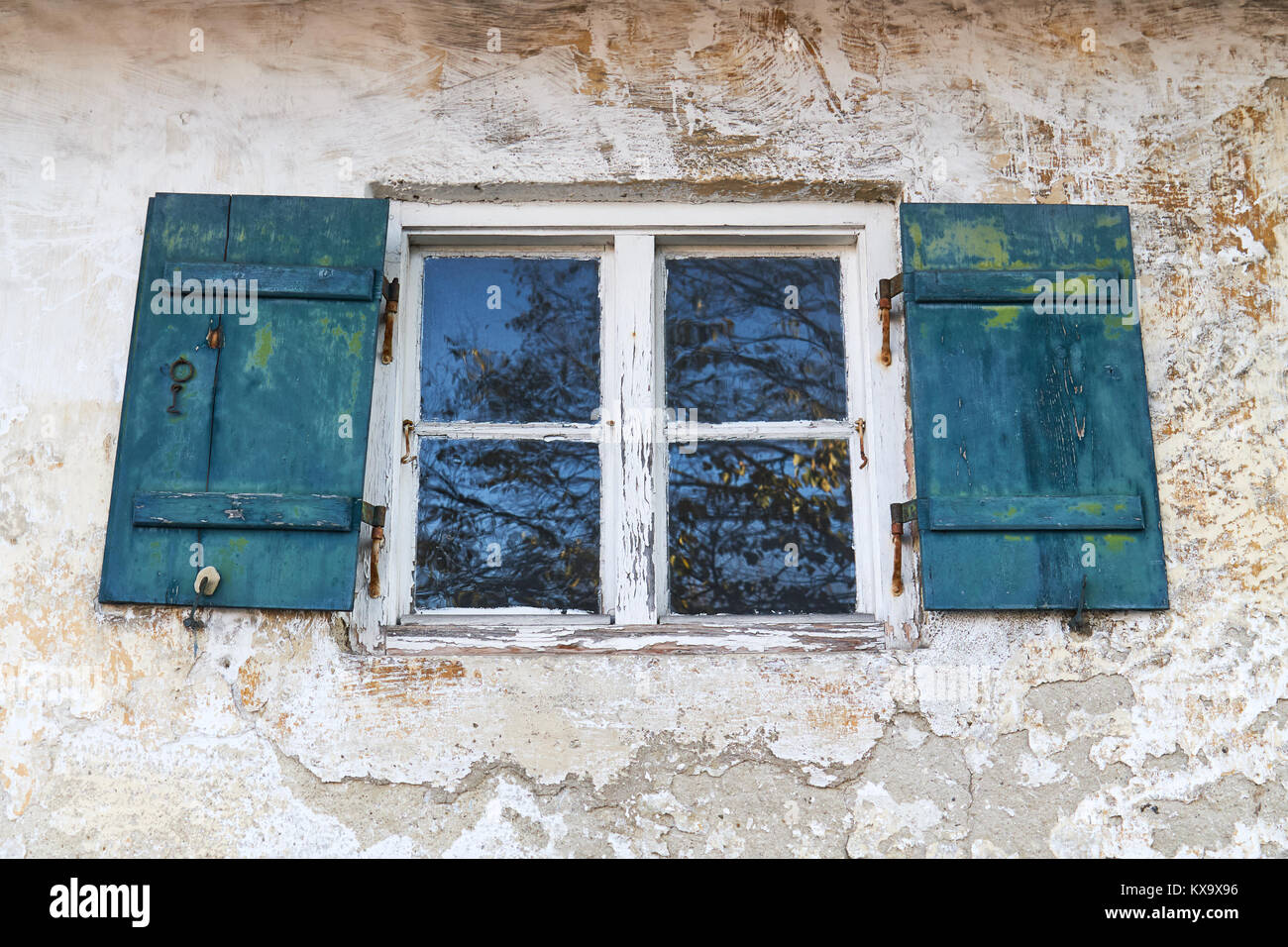 Old rustic window with wooden shutters on white house Stock Photo - Alamy