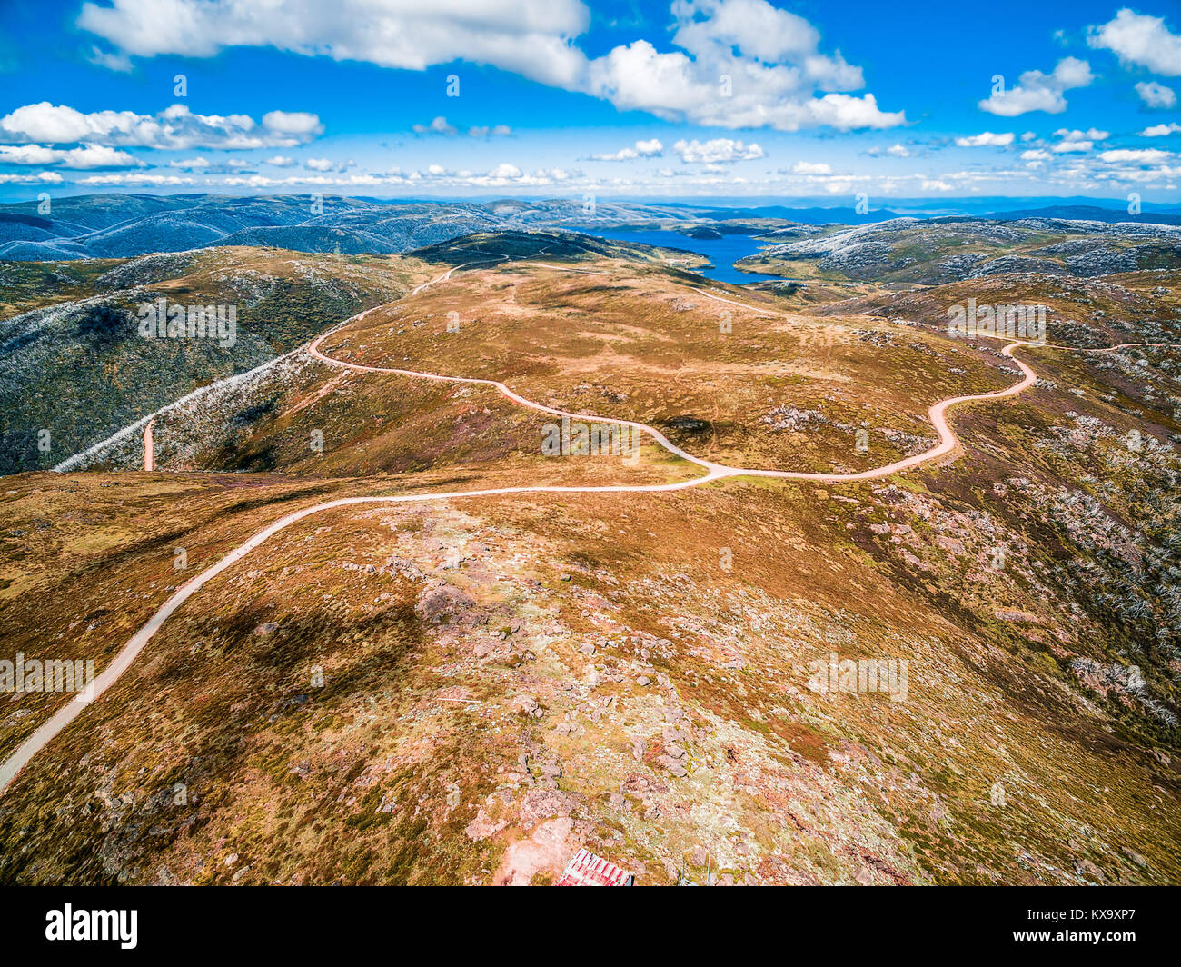 Aerial view of beautiful mountains and winding road on bright sunny day ...