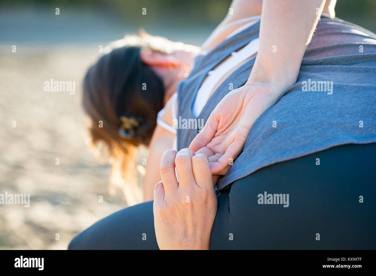 Woman practicing yoga in the sand - Extended Side Angle Pose — Utthita Parsvakonasana - Autumn day Stock Photo