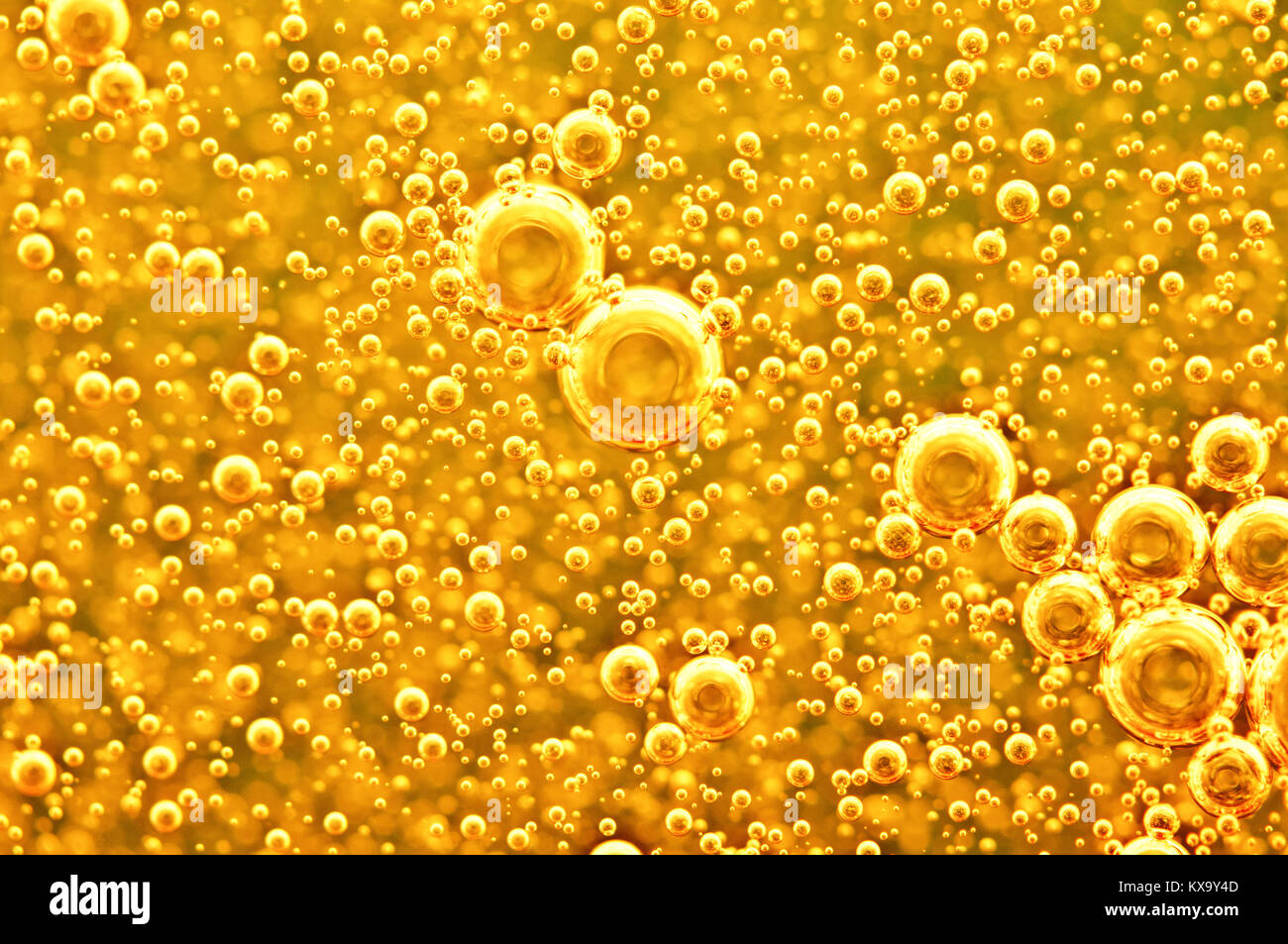Golden background with big and small gold bubbles oil inside a gold liquid. Stock Photo