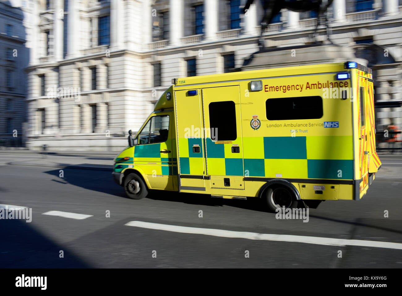 Ambulance racing at speed on Whitehall, Westminster, London on a blue light call. NHS Emergency Ambulance. Responding to call. Speeding. Fast Stock Photo
