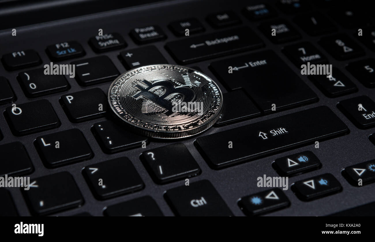 One Silver Bitcoin On Laptop Keyboard As Internet Currency Money - 