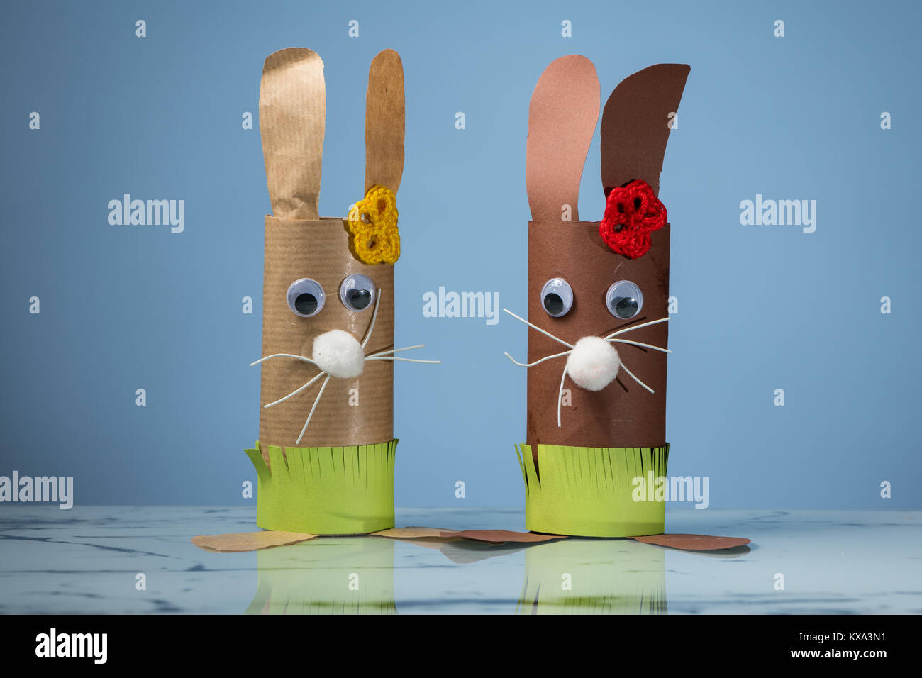 Closeup of two Easter bunnies made of toilet paper rolls by a child