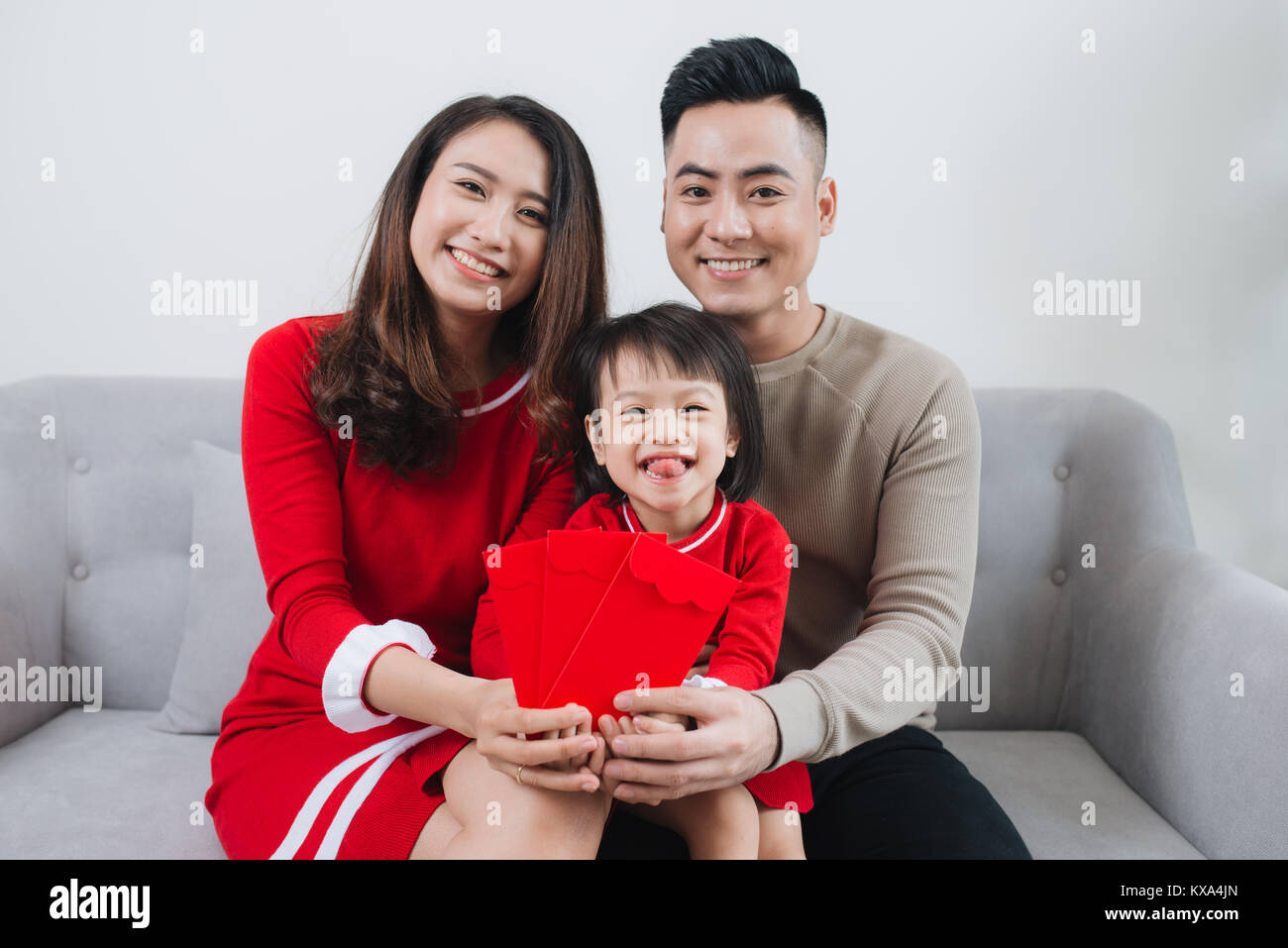 Happy Vietnamese family celebrate Lunar new year at home. Stock Photo