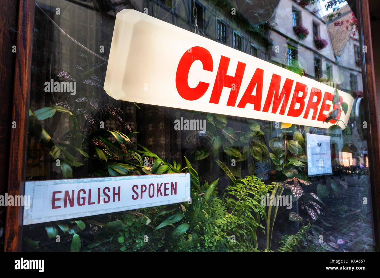 FRENCH B&B 'Chambres' Gite sign in French window with ‘English Spoken’ label alongside Stock Photo
