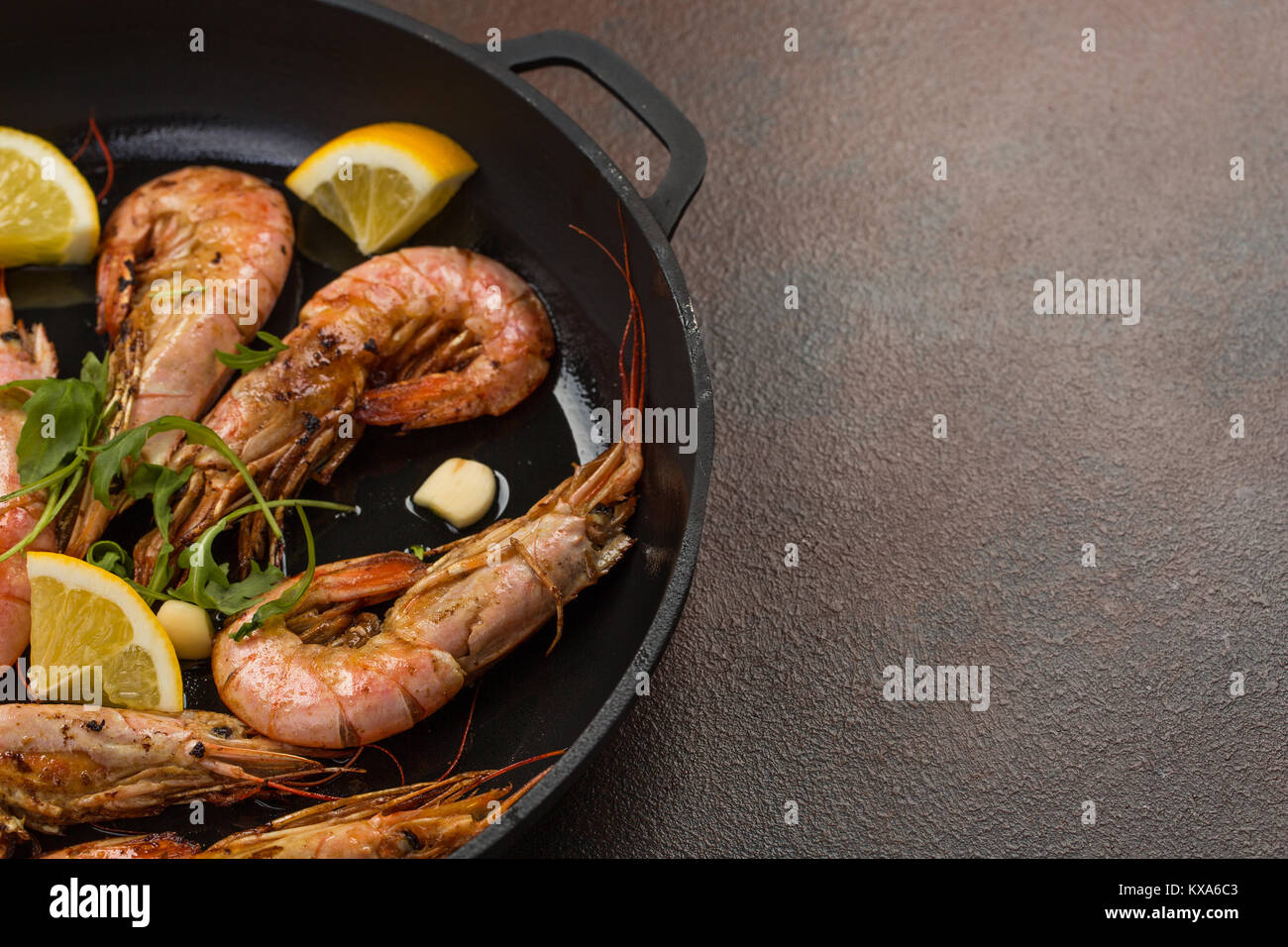 prawns shrimps with garlic, lemon, spices and italian parsley garnish