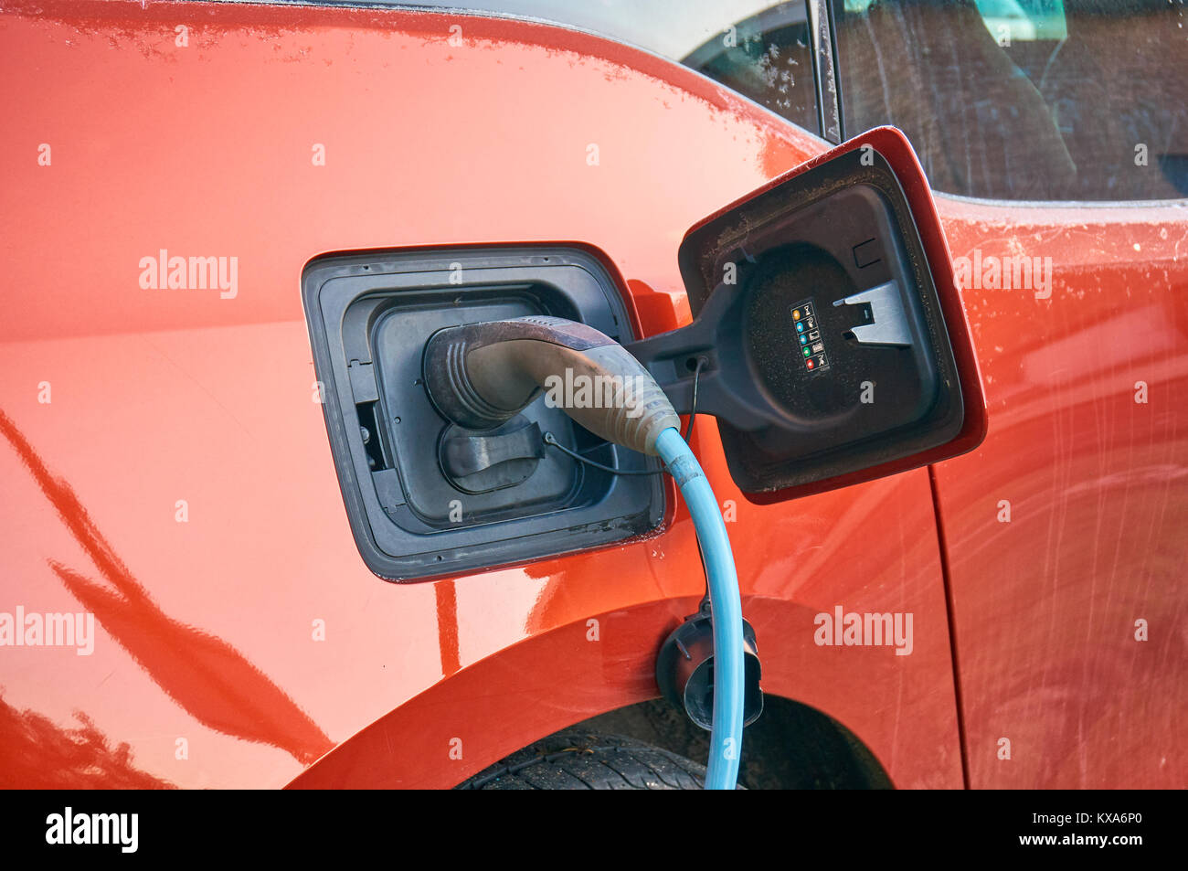 Electric car parked and connected to a charging station Stock Photo Alamy