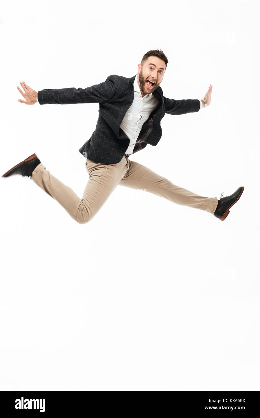 Full length portrait of a cheery happy man celebrating success while  jumping isolated over white background Stock Photo - Alamy