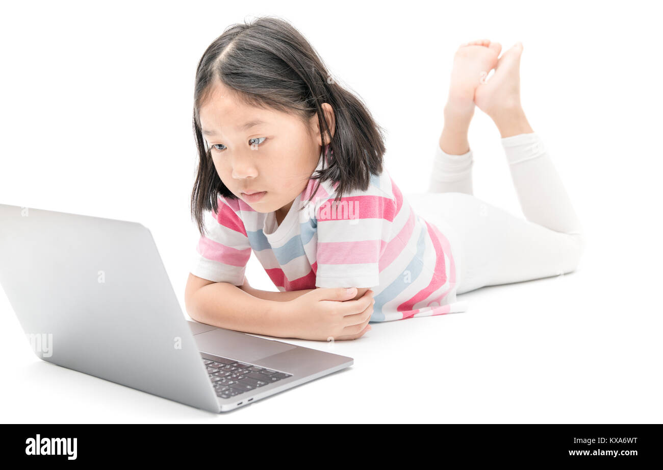 little girl look at monitor laptop isolated on white background, Computer vision syndrome problem concept Stock Photo