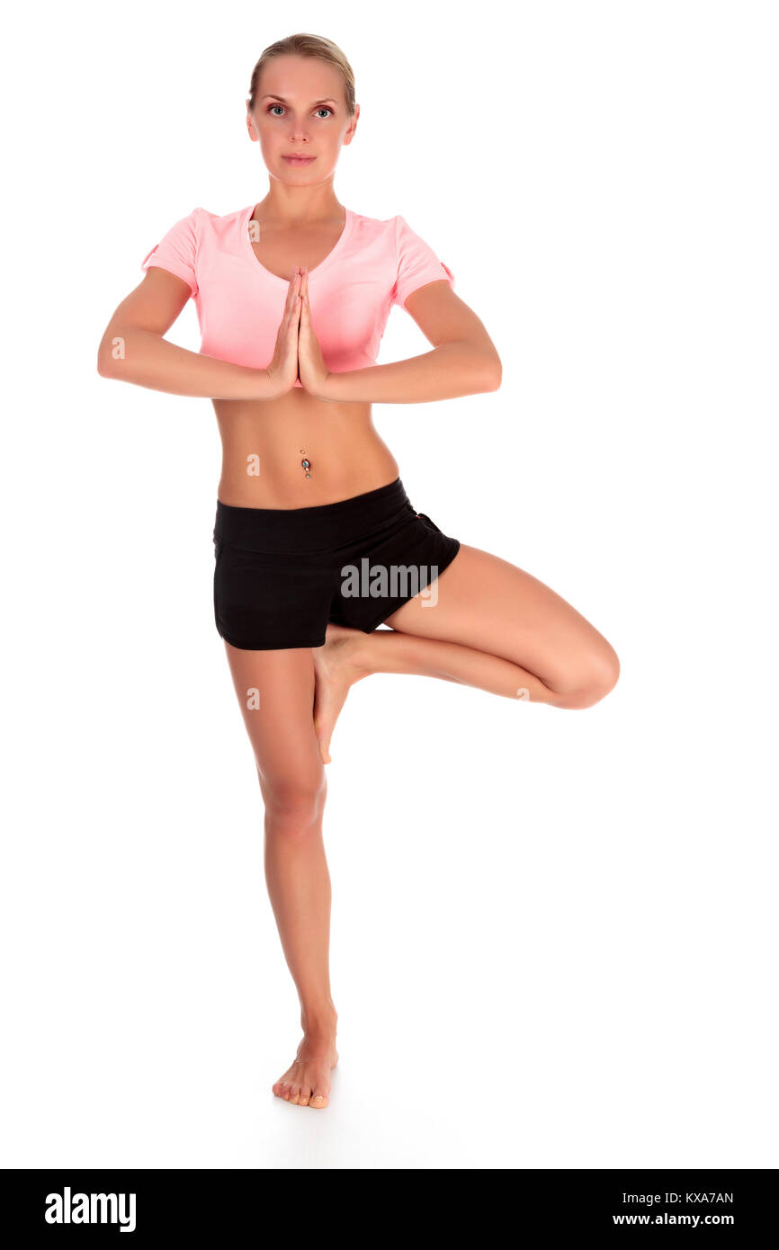 Full length portrait of a beautiful slim woman doing yoga exercise, isolated on white background Stock Photo