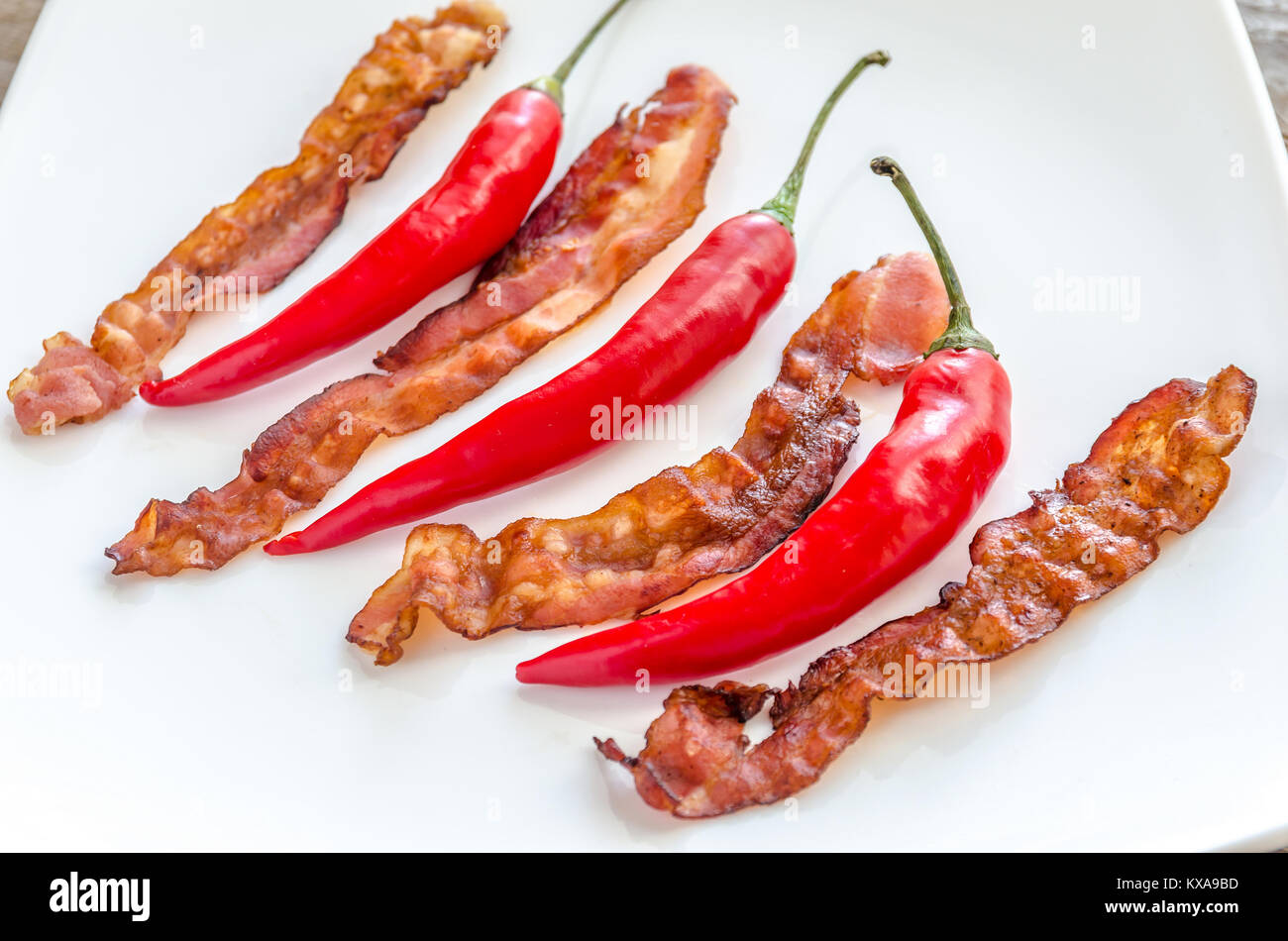 Fried bacon strips with chili pepper Stock Photo Alamy