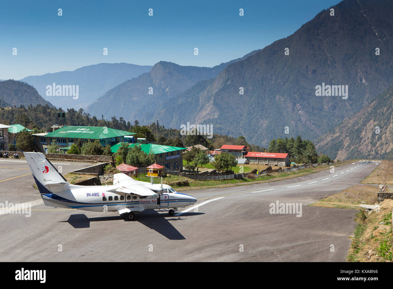 A small airplane is taking off from the famous airport of Lukla in the Nepalese Himalaya. Stock Photo