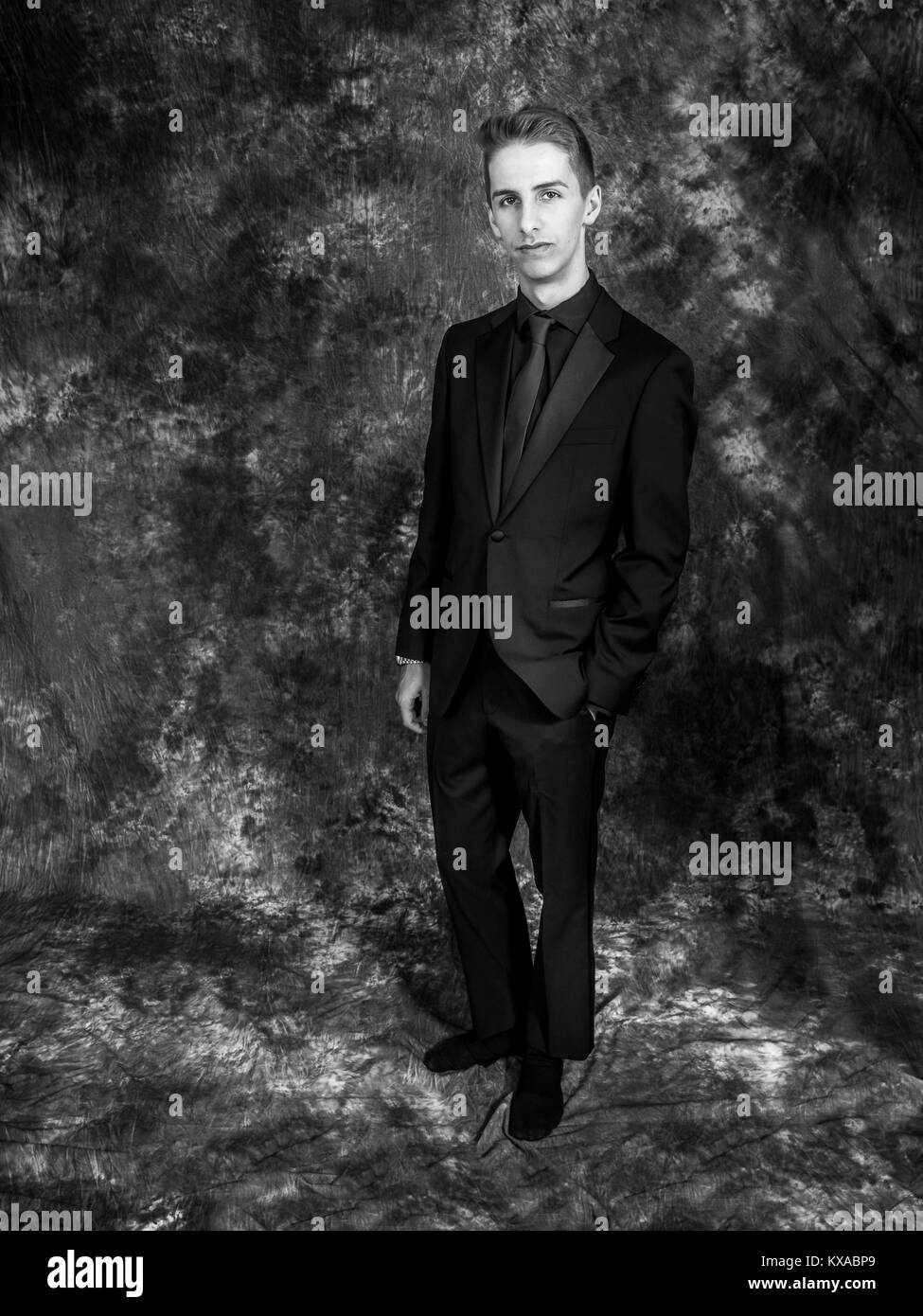 Young man wearing a black suit Stock Photo Alamy