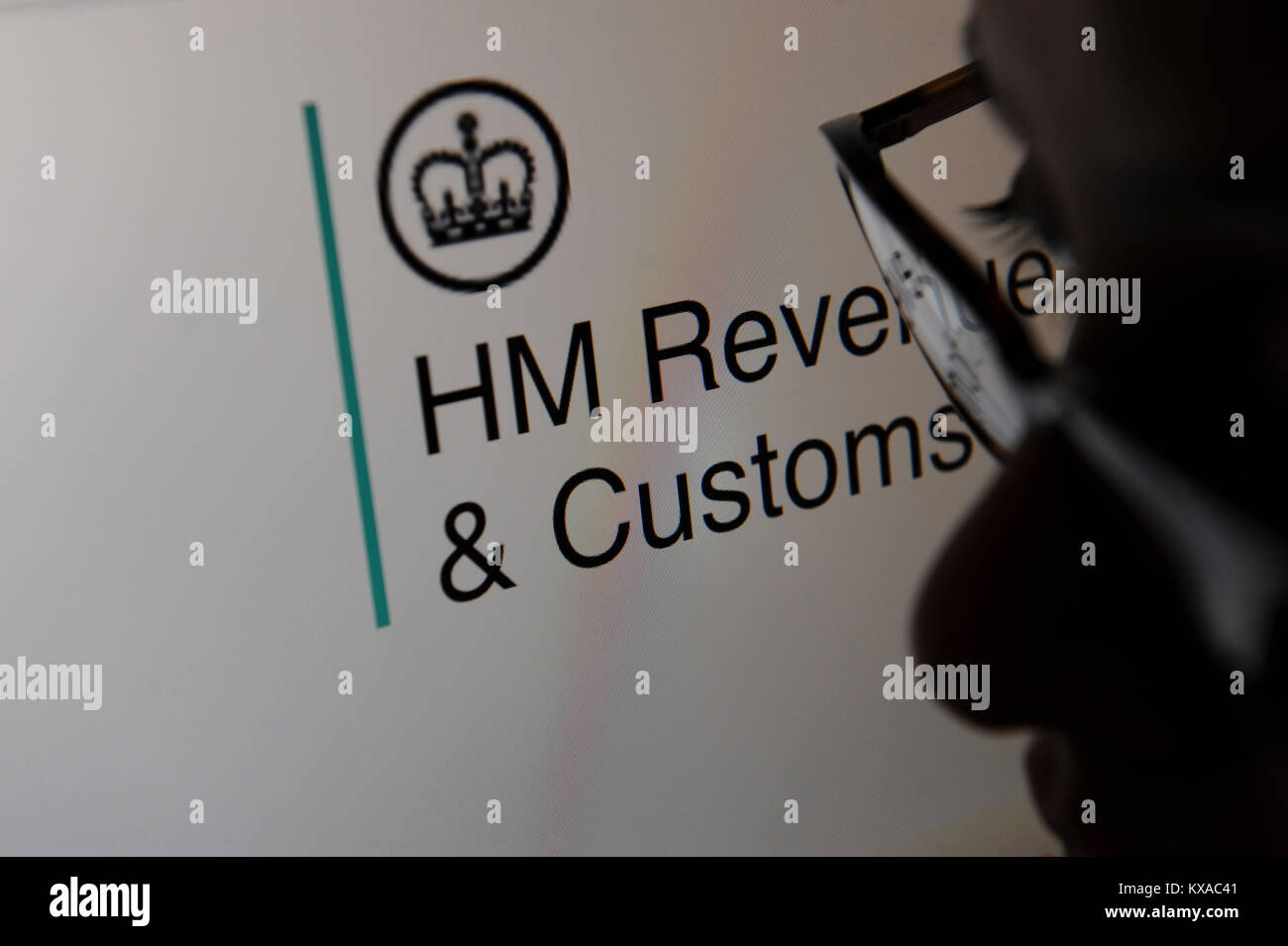 A woman looks at the HM Revenue and Customs, Gov.UK website on a computer Stock Photo