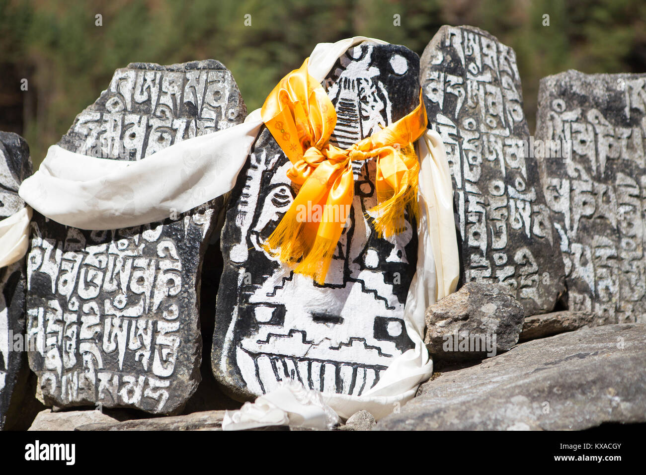 A Buddhist monument on the way to Everest Base Camp. Mani walls with mantras, a stupa and prayer flags.  In the evenings you will be rewarded with delicious Nepalese cuisine around the dining-room fire while sipping Sherpa tea and conversing with other like-minded travelers. Stock Photo