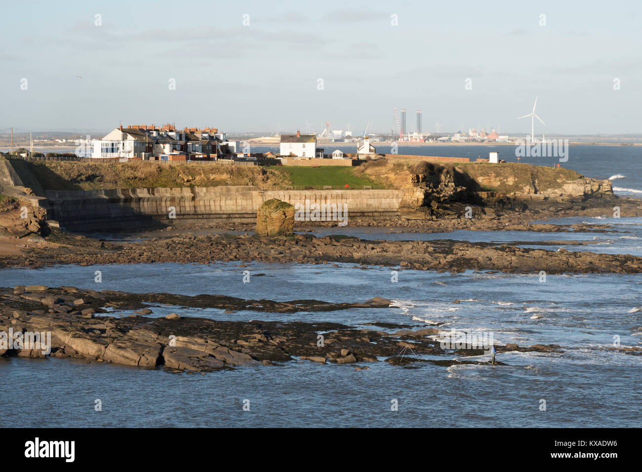 Collywell Bay, the sea wall and the headland at Seaton Sluice with Blyth in the background, Northumberland, England, UK Stock Photo