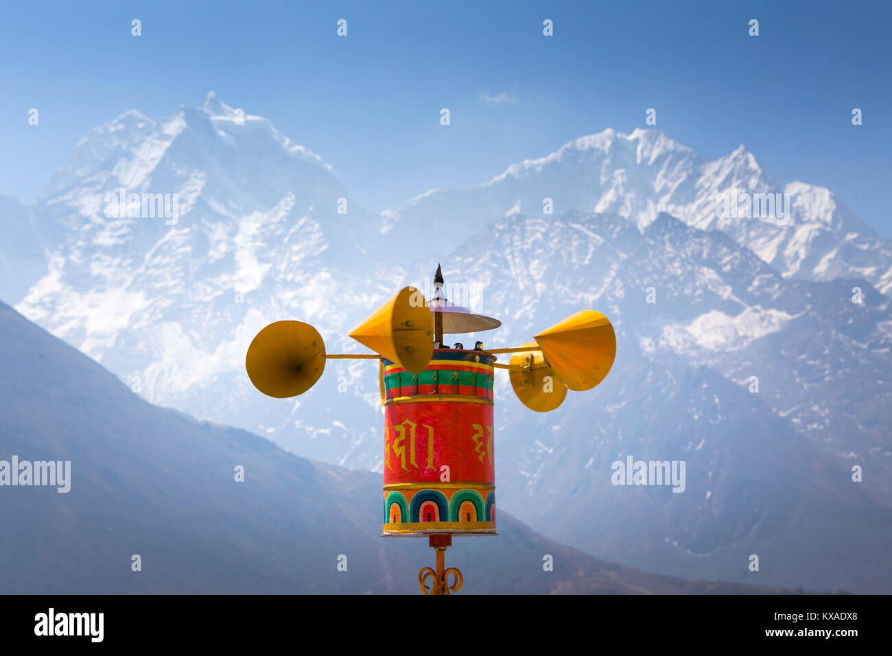 A prayer wheel turning in the wind and spreading Buddhist mantras at Pangboche Monastery, a famous Buddhist place in the Nepalese Khumbu Valley. Stock Photo