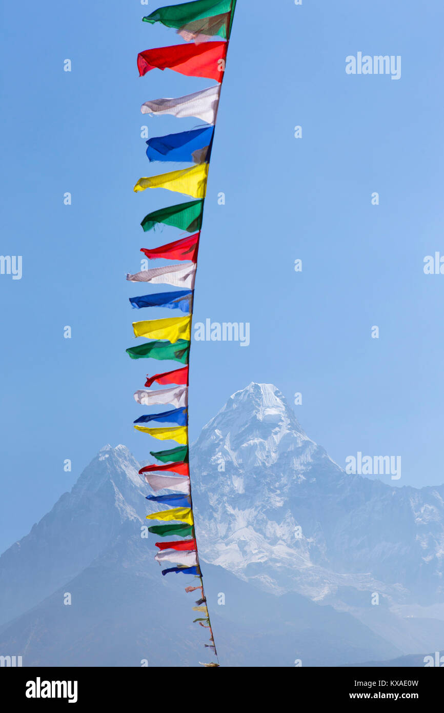 Prayer flags waving in the wind at Pangboche Monastery, a famous Buddhist place in the Nepalese Khumbu Valley. Stock Photo