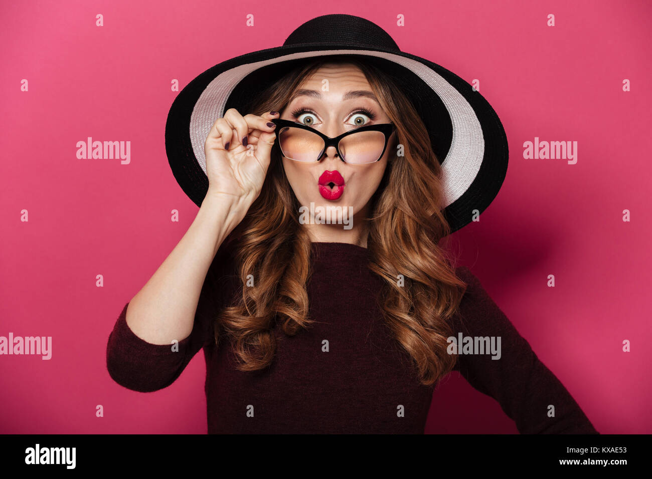 Picture of young shocked lady wearing hat and glasses standing isolated