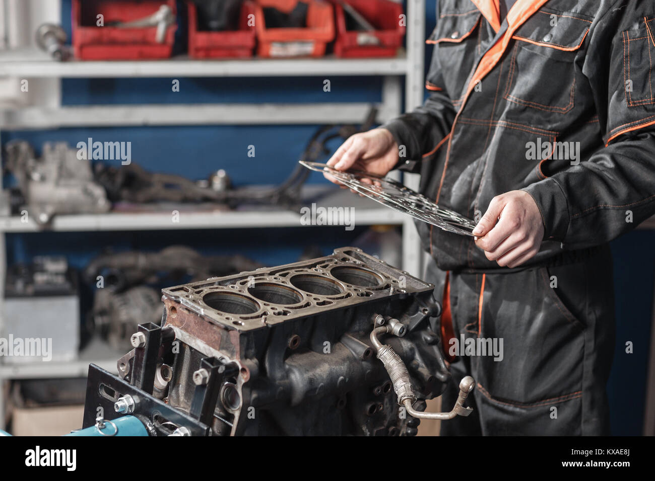 Sealing gasket in hand. The mechanic disassemble block engine vehicle