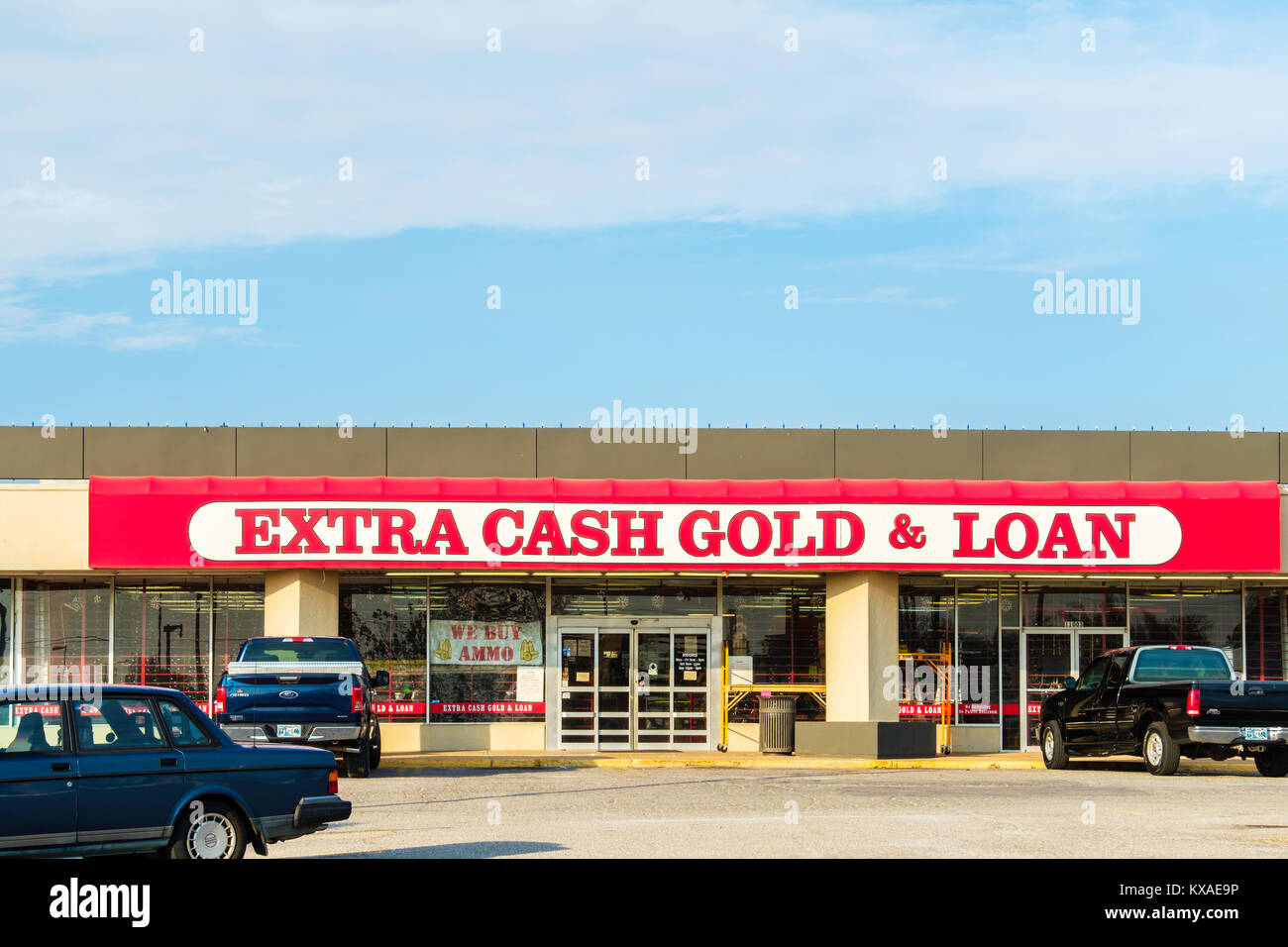 A pawn shop advertising extra cash, gold and loans in a shopping center in Oklahoma City, Oklahoma, USA. Stock Photo