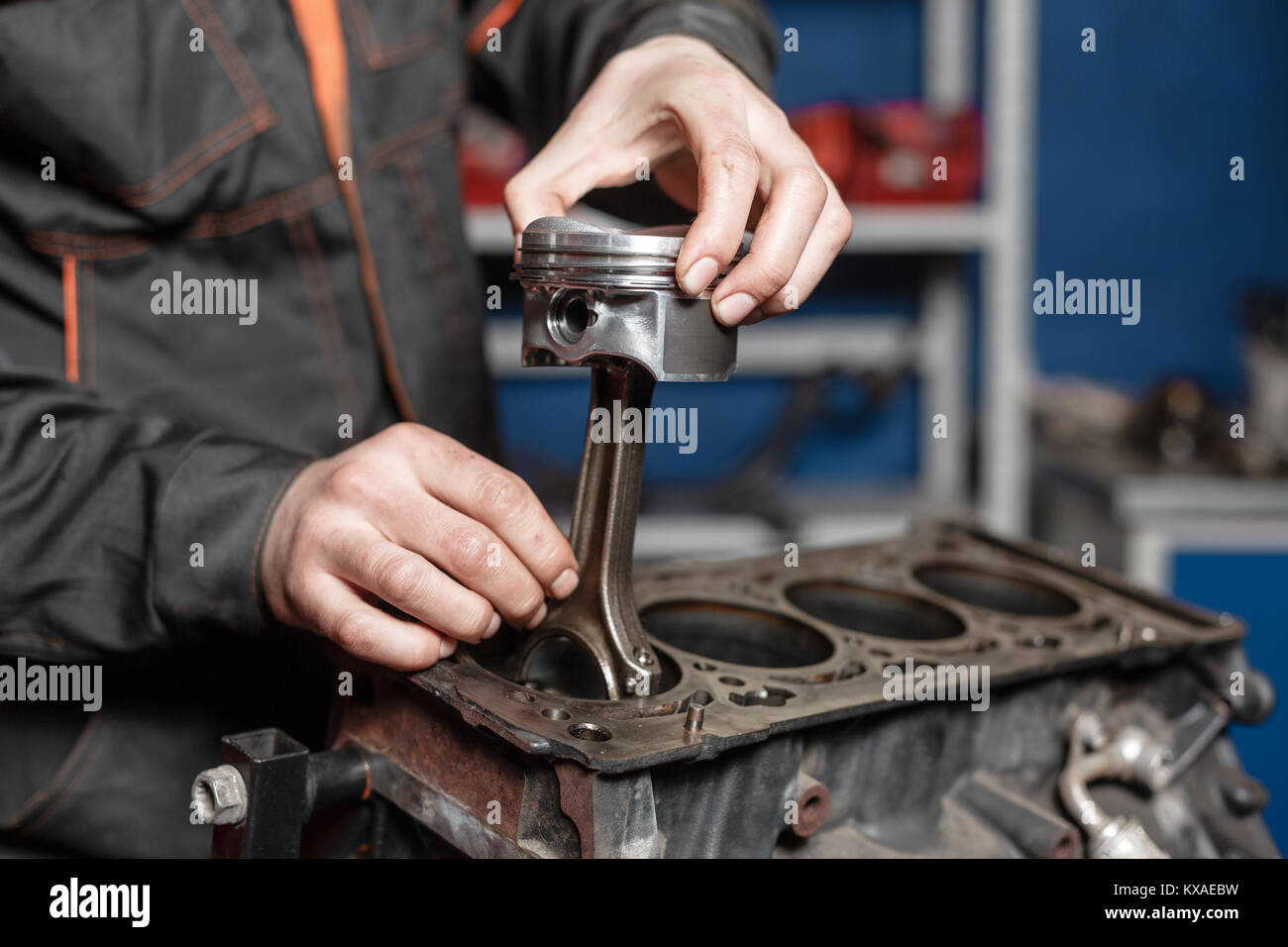 the mechanic installs a new piston. Disassemble engine block vehicle
