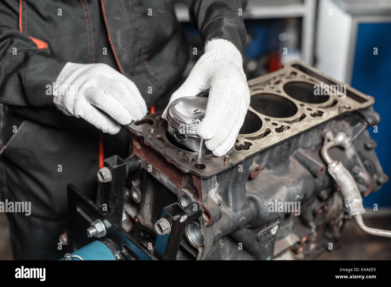 the mechanic installs a new piston. Disassemble engine block vehicle