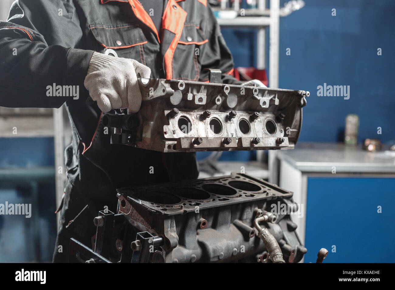 The mechanic disassemble block engine vehicle. Engine on a repair stand