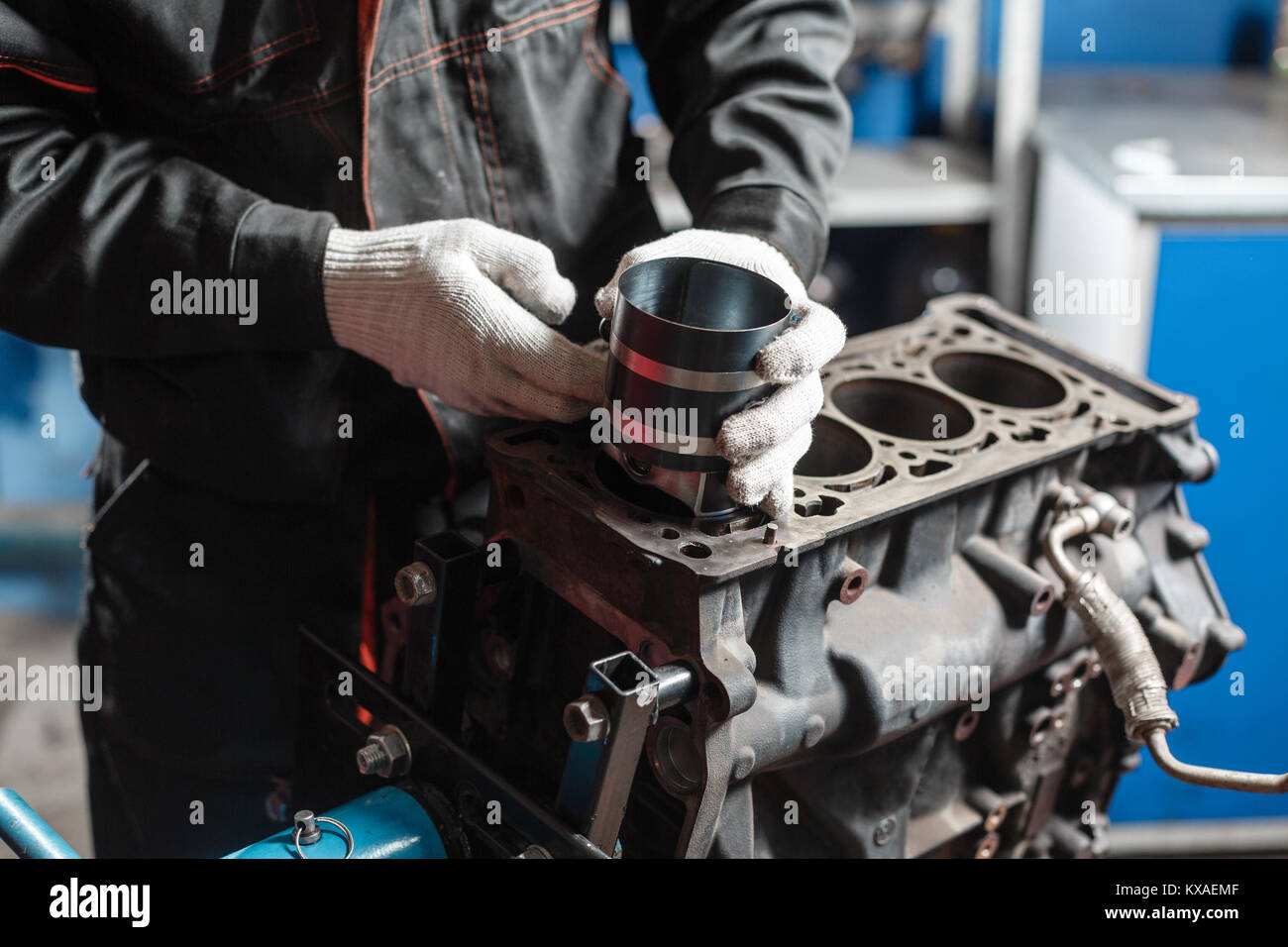 the mechanic installs a new piston. Disassemble engine block vehicle
