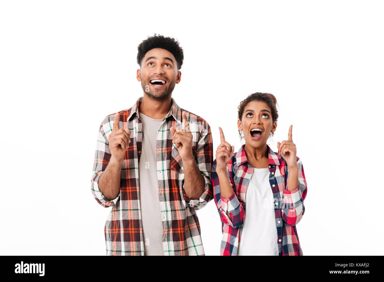 Portrait of an excited young african couple standing together and ...
