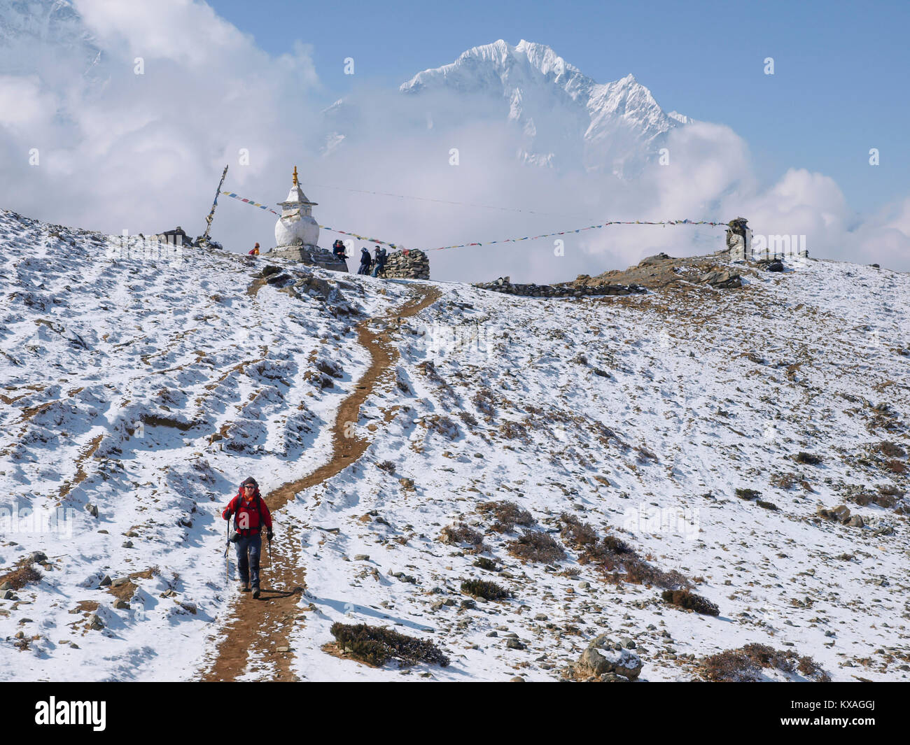 Hiker walking in snowy landscape of mountain pass in Nepalese Khumbu valley, Pheriche, Nepal Stock Photo