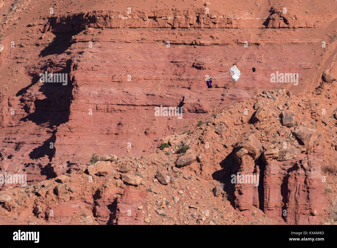 December 4, 2017 - Moab, Utah, U.S - A wingsuiter, a step above BASE jumping, pulls his chute after free falling and flying in Moab, UT. (Credit Image: © Deleigh Hermes via ZUMA Wire) Stock Photo