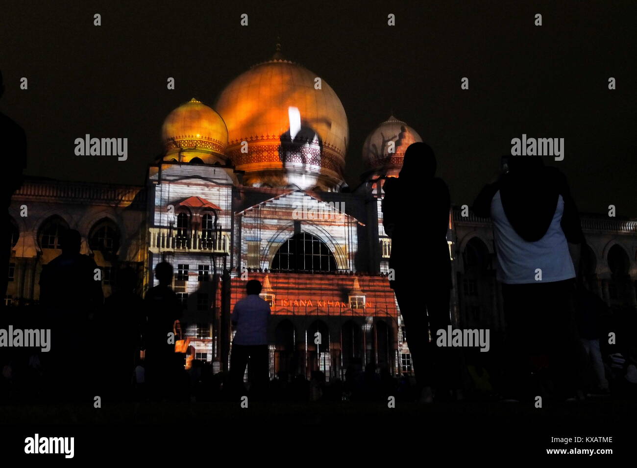 KUALA LUMPUR, MALAYSIA - DECEMBER 28: People watch a Palace of Justice building is cover by Projection Mapping during the Putrajaya Lighting Festival on December 28, 2017 in Putrajaya, Malaysia. The four-night festival featured a light art communities and university students in Malaysia showcasing their creativity of light-themed events, including Luminous lighting effect show, decorative arch and light structure exhibits, car light show, night fun ride, wayang kulit performance (shadow puppetry), and a light garden . Credit: Samsul Said/AFLO/Alamy Live News Stock Photo
