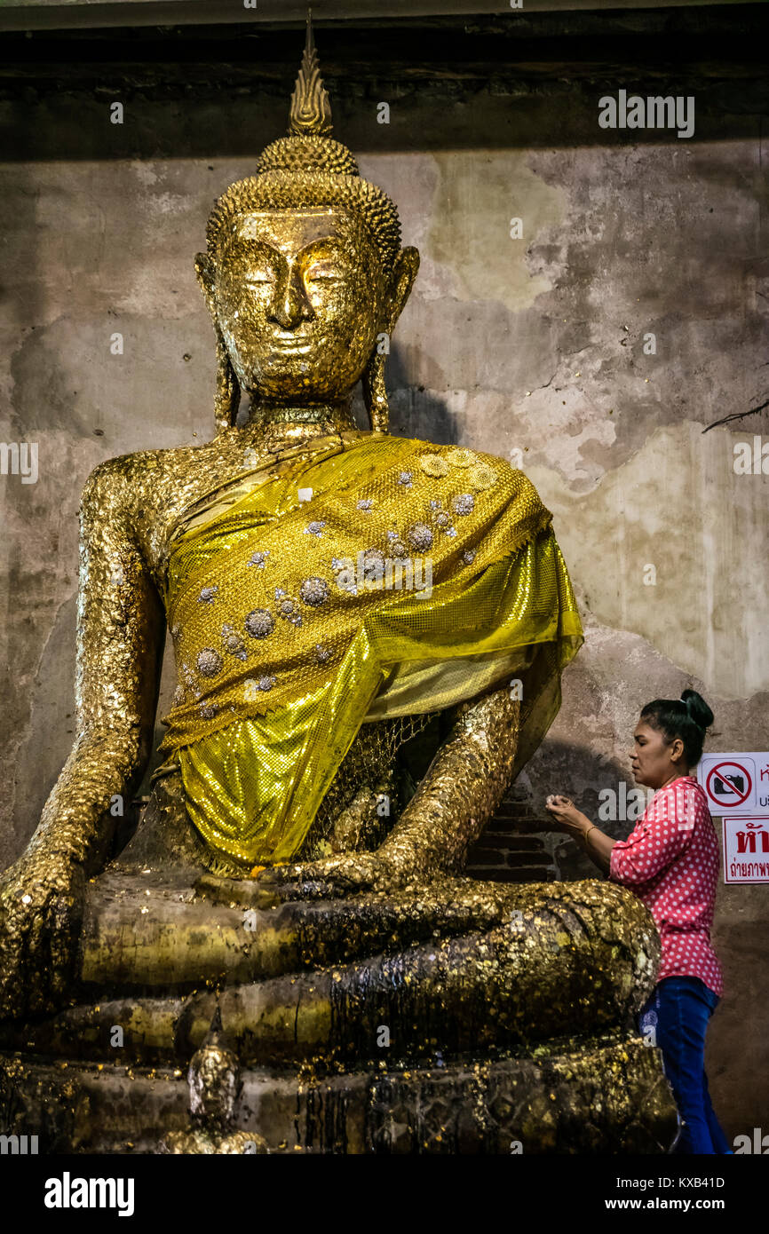 Thai worshiper making offering to the Statue of Buddha, Ordination Hall, Bang Kung Camp, Samut Songkhram, Thailand. Stock Photo