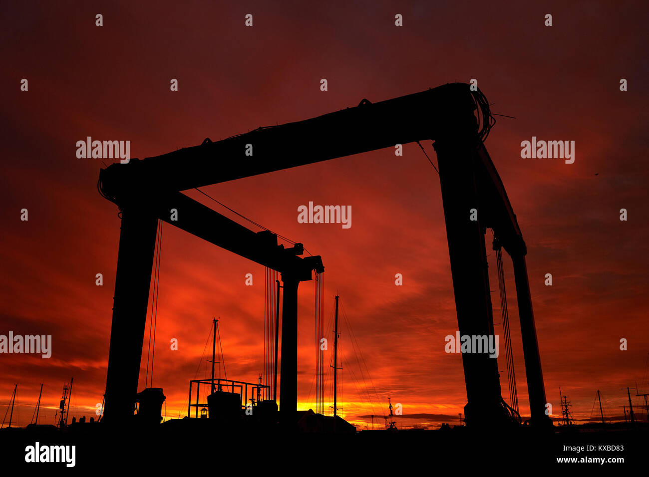 Sunset over Hartlepool Marina. A boat lift in Silhouette Stock Photo