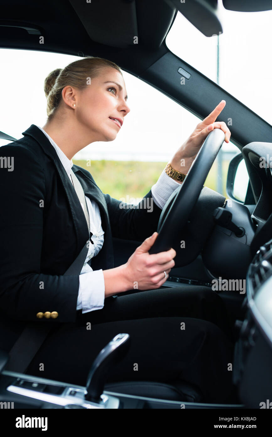 Woman in car being angry cursing other driver Stock Photo