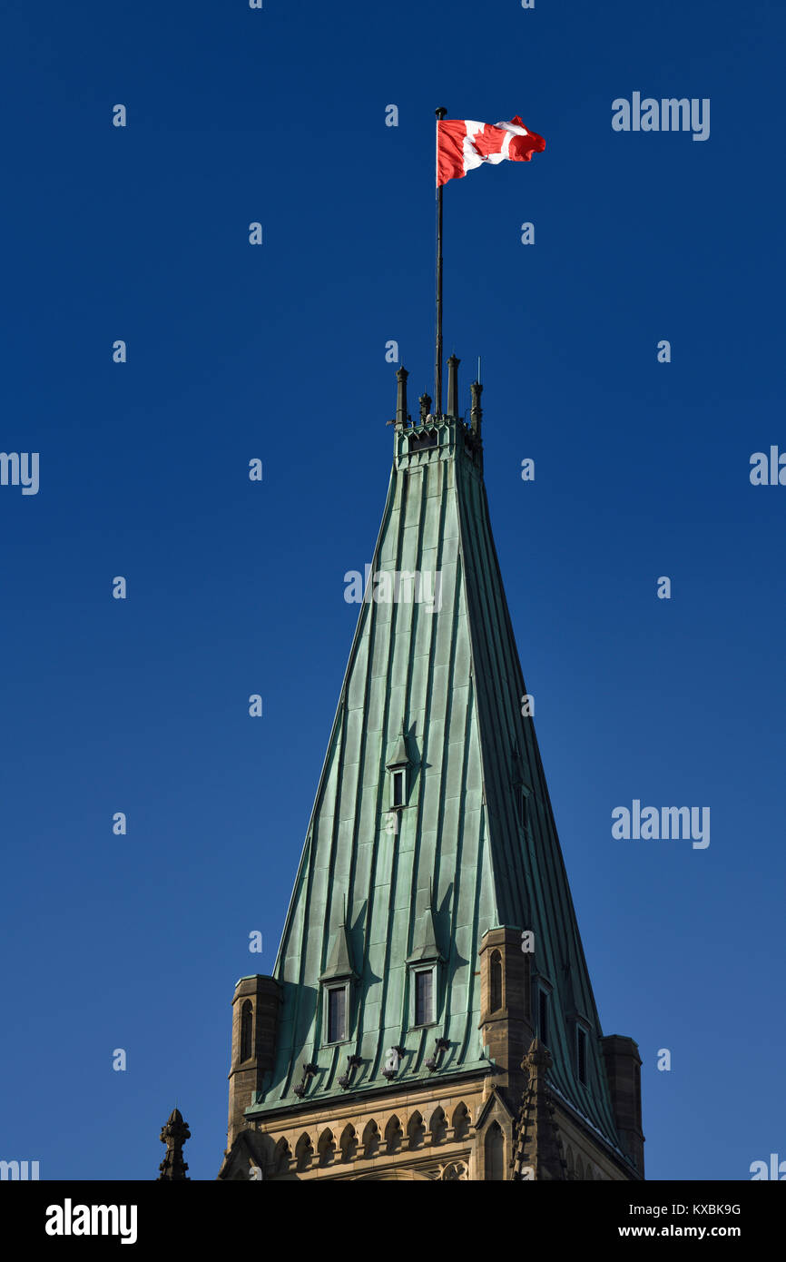 Roof of concrete covered with copper at the Parliament Buildings Peace Tower with Canadian flag on blue sky Ottawa Canada Stock Photo