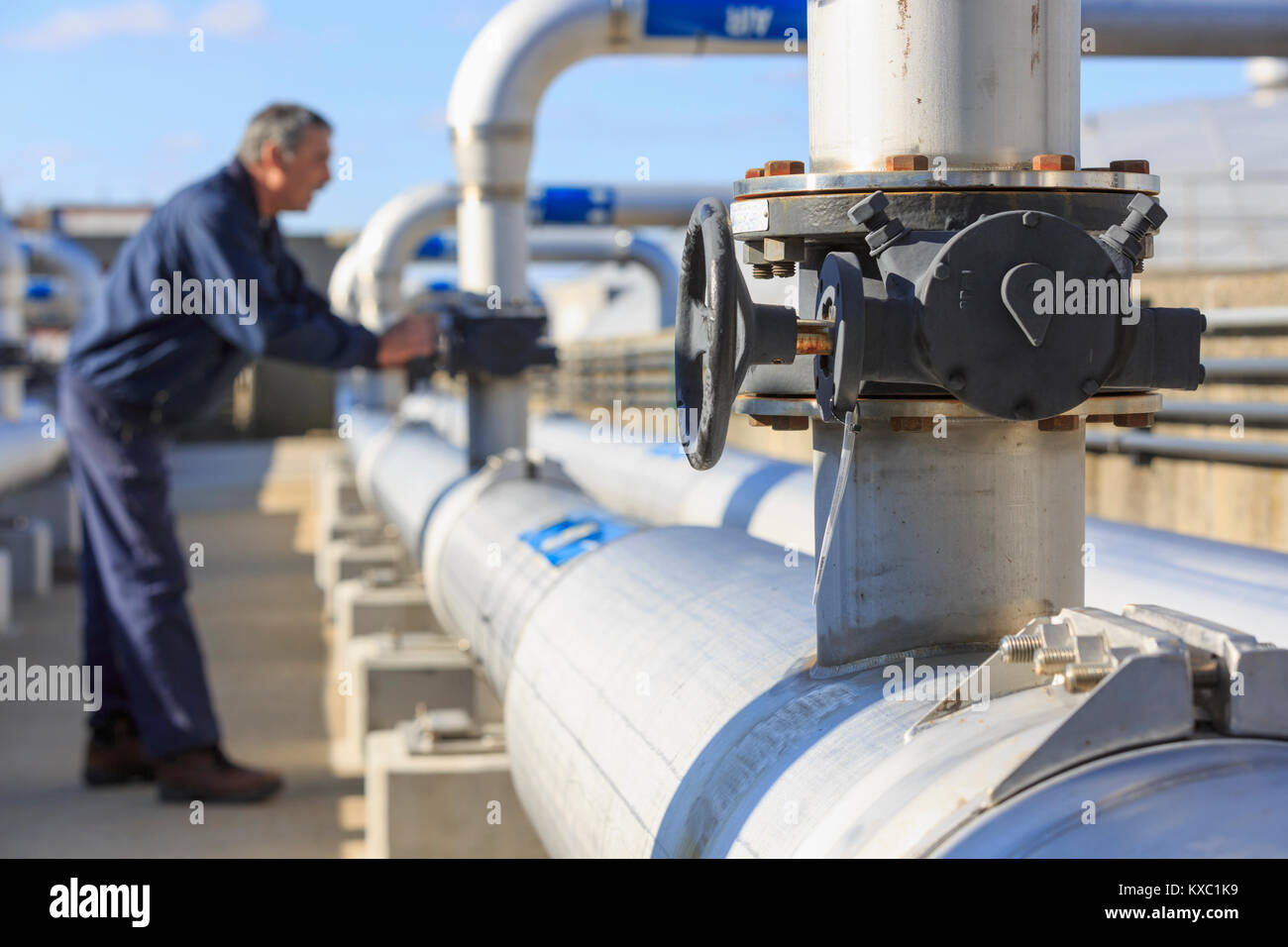 Engineer adjusting water flow control valve Stock Photo Alamy