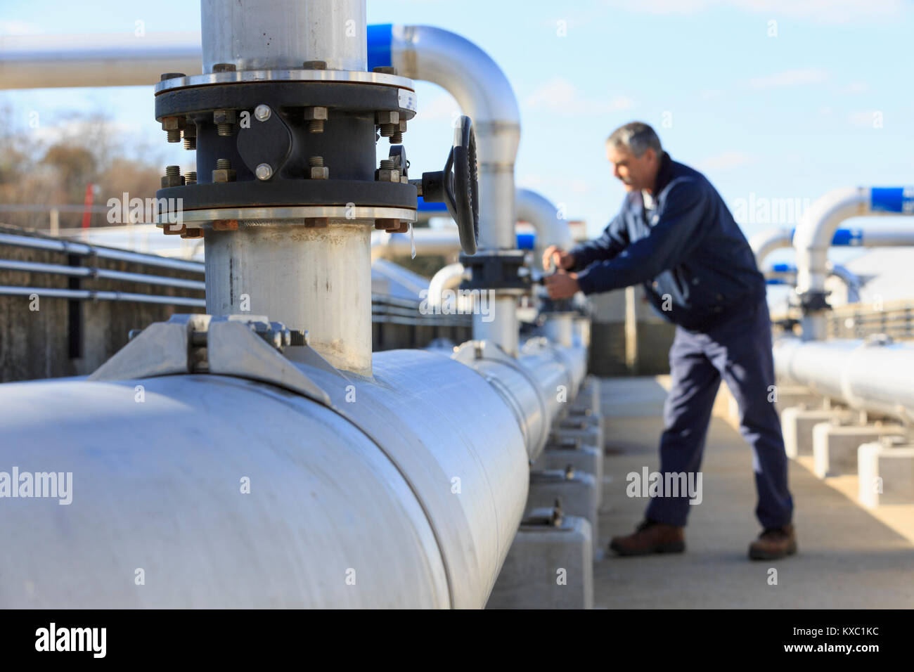 Engineer adjusting water flow control valve Stock Photo Alamy