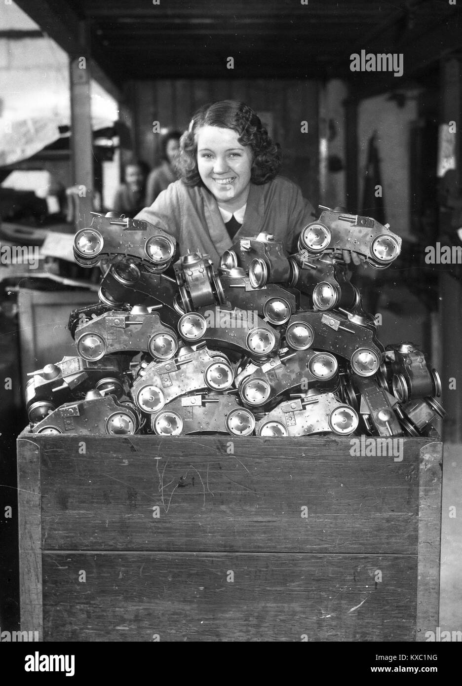 Woman working packing toys at Tri-ang toy 'Tiger' climbing tanks at Lines Brothers Ltd Tri-ang works in Merton, London 1936 Stock Photo
